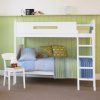 Pure white Little Folks Furniture bunk bed with a green tongue and groove wall