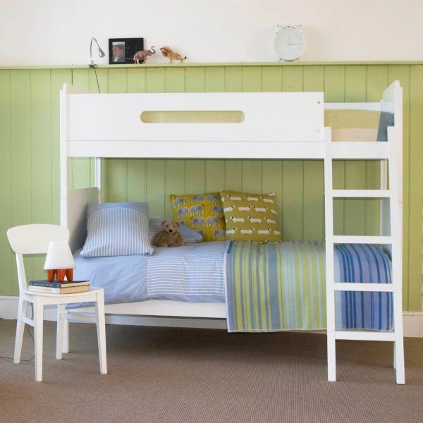 Pure white Little Folks Furniture bunk bed with a green tongue and groove wall