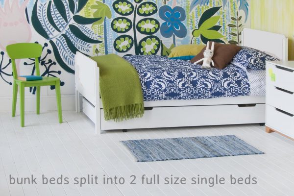 Twin bed; bunk bed divides into two full size single beds, with green chair and chest of drawers, large scale wall mural on the wall