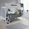 Grey and white bunk bed that divides into two beds, against grey tongue and groove panelled wall.