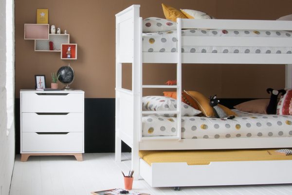 Beech bunk bed, fixed ladder and trundle for storage and sleepovers, next to trendy chest of drawers, with a mid century modern design