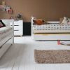 Convertible Classic Beech bunk beds, divided into 2 full size single beds and trundle beds underneath.