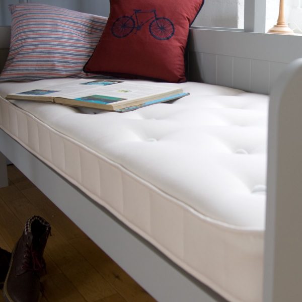 Close up of the tufting detail on a sofa bed mattress