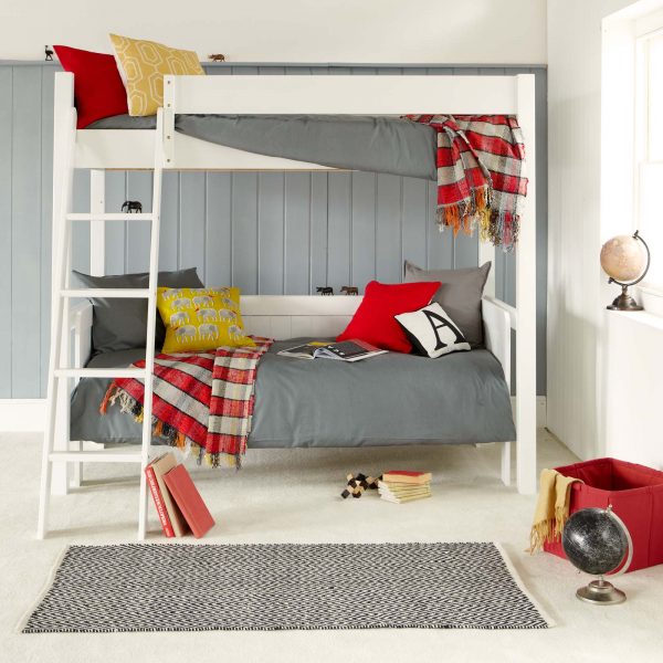 white children's classic loft bed with a sofa bed underneath, in a travel inspired bedroom for sharing siblings