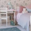 Fargo sturdy child's study desk with storage, in ivory white, shown in a girls classic bedroom