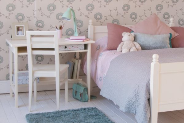 Fargo sturdy child's study desk with storage, in ivory white, shown in a girls classic bedroom