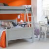 Orange child's room with double bed and high sleeper bed over the top