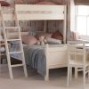 White bunk bed with small double bed and bookcase underneath, girls bedroom