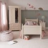 Cream kids single bed and wardrobe with open door in girls bedroom with butterflies on wall