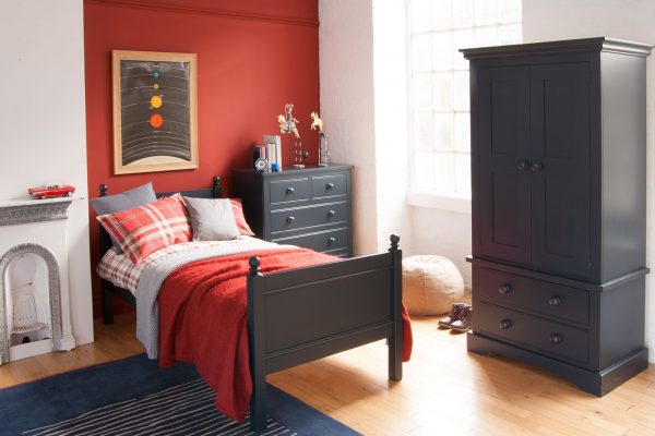 Fargo single bed in navy blue, with an oak floor, classic bedroom