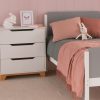 Close up of a mid century modern style chest of drawers and grey and white girls modern bed with a retro style