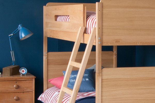 Close up detail of the EDIT bunk bed ladder and side, with a blue bedroom background