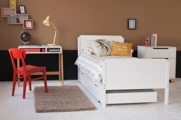 white single bed with trundle with scandi desk and red chair
