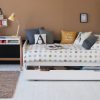 Edit bed with storage trundle and desk in tan and black bedroom