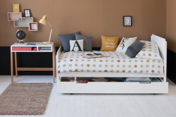 Edit bed with storage trundle and desk in tan and black bedroom