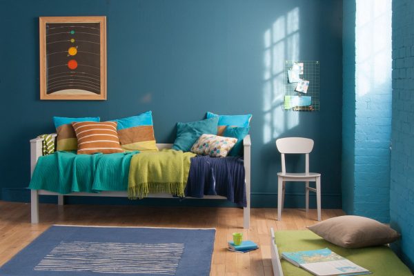 Kids daybed in a space themed room, with sleepover trundle pulled out into the bedroom