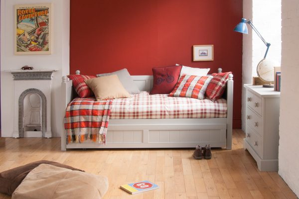 Red and grey boy's bedroom with daybed and trundle underneath, red cars, vintage styling